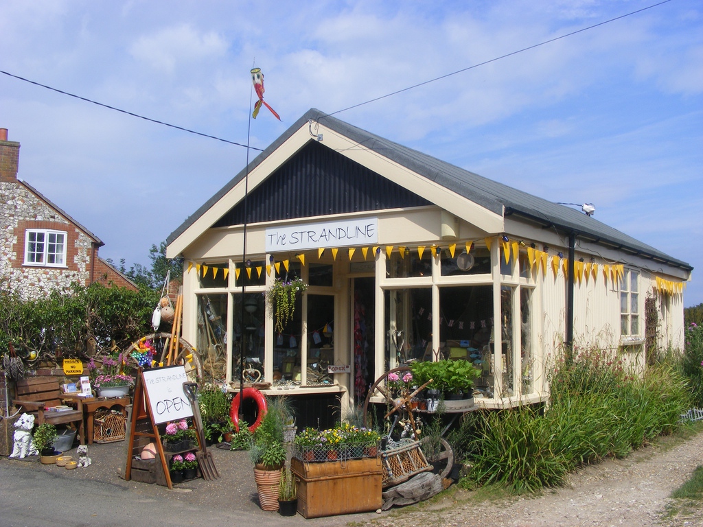 The Strandline, a charming seaside shop decorated with bunting