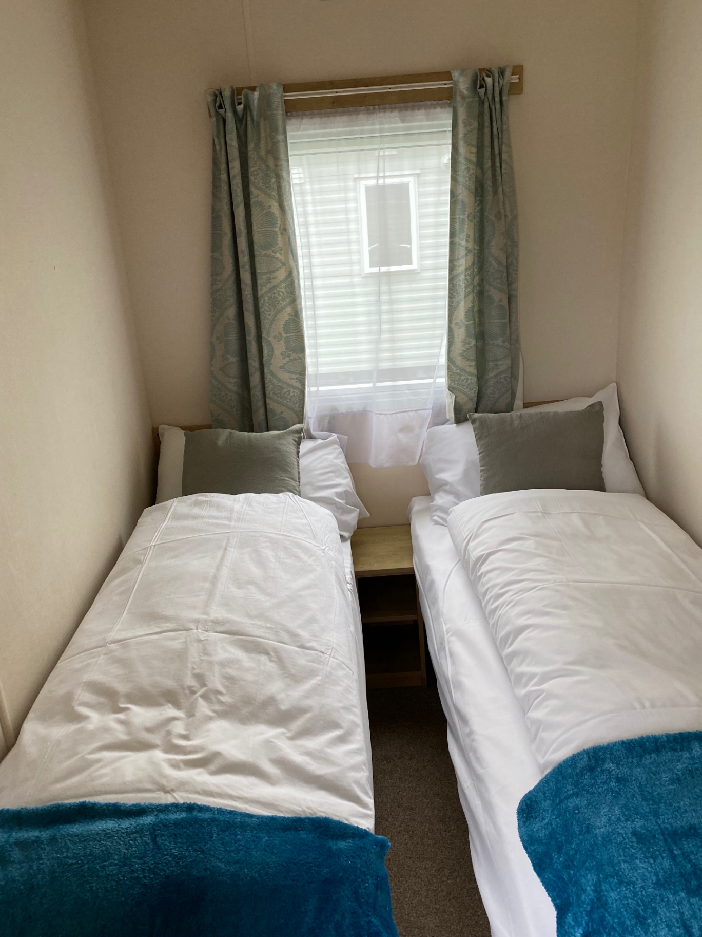 Twin bedroom with blue throws