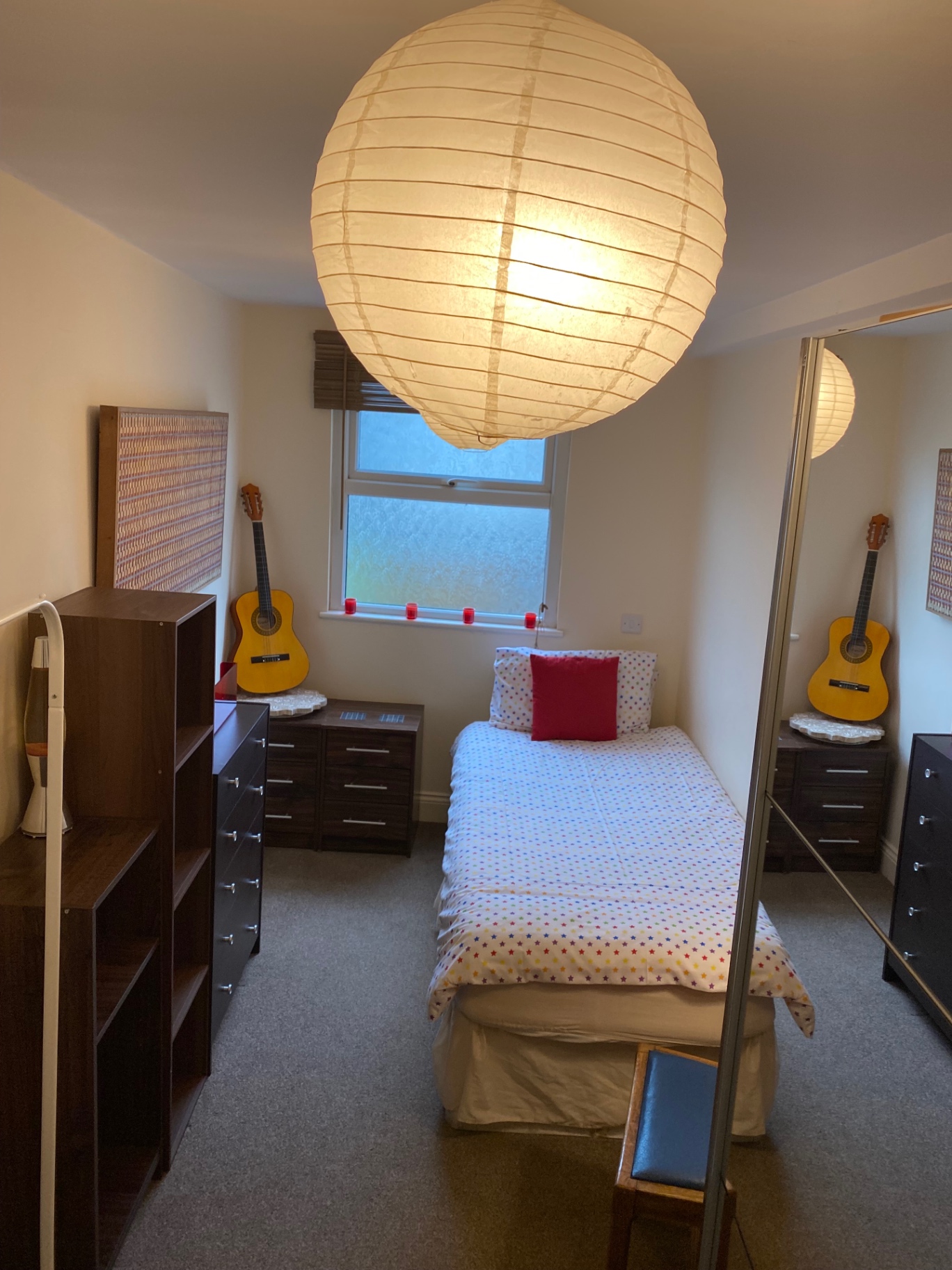 Bedroom with single bed and guitar